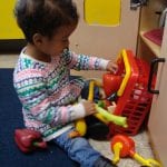 student playing with toy food