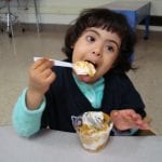 Student eating pudding