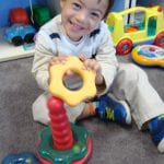Student playing with rings on a post