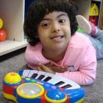 Student playing with piano