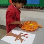 student painting with corks