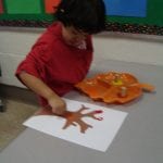 student painting with corks