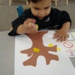 student painting with corks