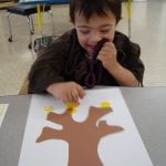 student painting with corks