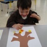 student painting with corks