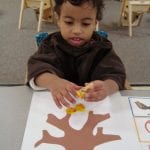 student painting with corks