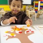 student painting with corks