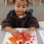 student painting with corks