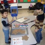 students playing with pretend cookies