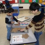 students playing with pretend cookies