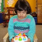 student with birthday cake