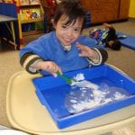 student finger painting