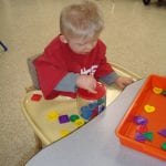 student working with button jar