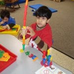 students working with pegs