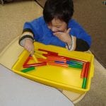 students working with pegs