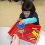 students working with pegs