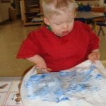 student finger painting