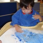 student finger painting