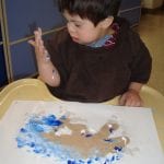 student finger painting