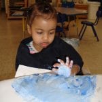 student finger painting