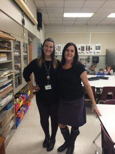 two teachers are dressed in the same purple and black colors.