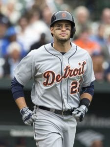 image of Martinez running with a batting helmet and a Detroit Tigers uniform on