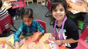We are creating our jack-o-lanterns using ripped orange paper glued onto a pumpkins shaped piece of brown paper.