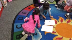 Students are sharing the fact they illustrated before writing the words to match.