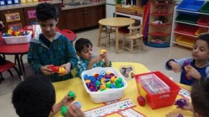 We are building strengthening our fine motor muscles in our hands as well as our hand eye coordination as we work with our table toys.