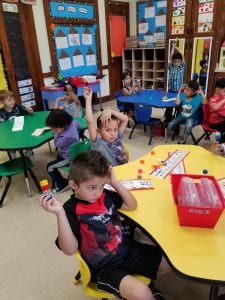 Counting to four with one to one correspondence and recognizing what a quantity of 4 looks like. 
