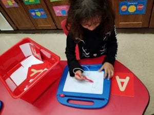 We are feeling the sandpaper letters and using our magic boards to practice writing the letters!