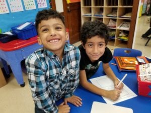 Book buddies working together to record their claim about pumpkins floating!