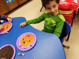 We worked the little muscles in our hands as we picked up little chocolate chips to decorate our pumpkin cookies like a jack-o-lantern!