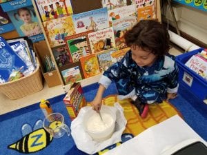 We are mixing the batter for our yummy pancakes!