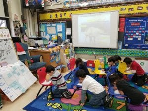 We practiced informational writing about reindeer by drawing and labeling the parts of a reindeer! We used our chairs for tables on the carpet!