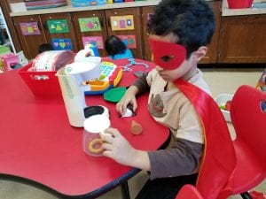 We have a super hero in our kitchen making coffee for the pretend restaurant.