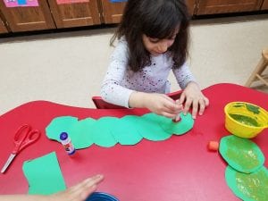 We used clothespins and puff balls to paint our caterpillars!