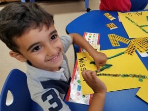 Then....we strengthened our fine motor muscles in our hands by placing small stickers on those letters!