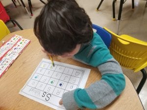 We searched for uppercase and lowercase letter Ss! When we sound it, we put a smiley or star sticker on the letter to help us remember; S says /s/ like at the beginning of star and sticker.