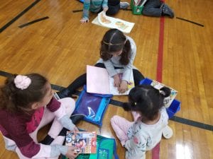 We read with our book buddies in the gym! Our book buddies are from Ms. Earle's 2nd grade!