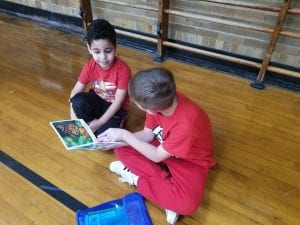 We read with our book buddies in the gym! Our book buddies are from Ms. Earle's 2nd grade!