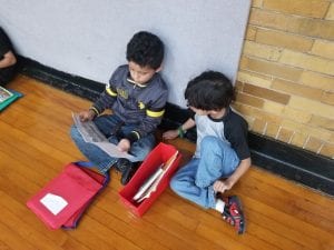 We read with our book buddies in the gym! Our book buddies are from Ms. Earle's 2nd grade!
