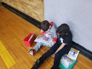 We read with our book buddies in the gym! Our book buddies are from Ms. Earle's 2nd grade!
