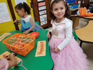 We also strengthened the muscles in our hands by using tongs to grab spiders out of the web to build our name and our friends' names!