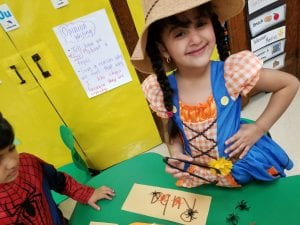 We also strengthened the muscles in our hands by using tongs to grab spiders out of the web to build our name and our friends' names!