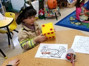We rolled dice to identify the number roll and color the number on our Halloween picture!
