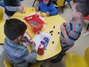 We are working in teams to help baby bear get to his mom as we make stairs of one more with unifix cubes!