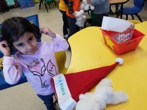 The Santa hat is longer than the bear!