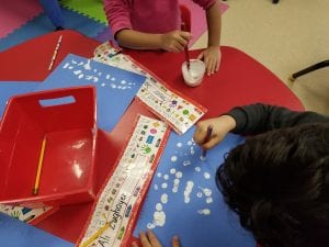 We created the snowy habitat for our polar bears as we dabbed erasers into white glittery paint.