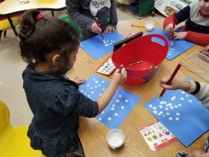 We created the snowy habitat for our polar bears as we dabbed erasers into white glittery paint.